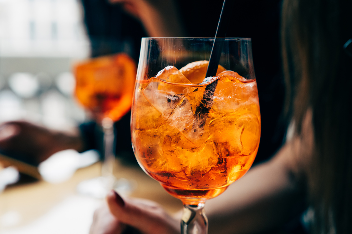 Close up of glasses with aperol spritz cocktails on the table